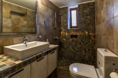 a bathroom with a sink and a toilet at OpenSea Villa in Thermisía