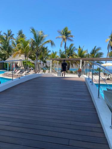 a boardwalk over the beach at the paradiso resort at Camino al mar "Departamento en playa" in Mazatlán