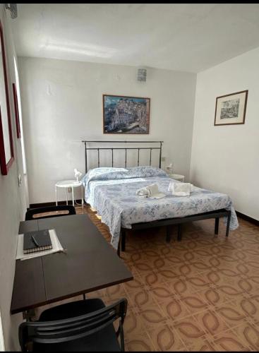 a bedroom with a bed and two tables in it at Mar-Mar Panoramica in Riomaggiore