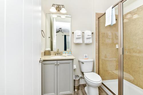a bathroom with a toilet and a sink and a shower at Margaritaville Cottages Orlando with H2O Waterpark by Rentyl in Kissimmee