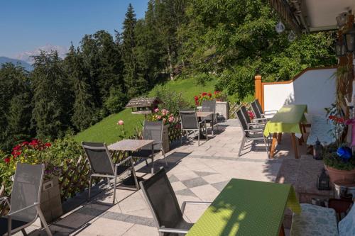a row of tables and chairs on a patio at Gästehaus Sonnenbichl in Berchtesgaden
