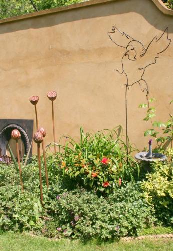 a garden with a painting of a deer on the side of a wall at The Claremont in Brighton & Hove