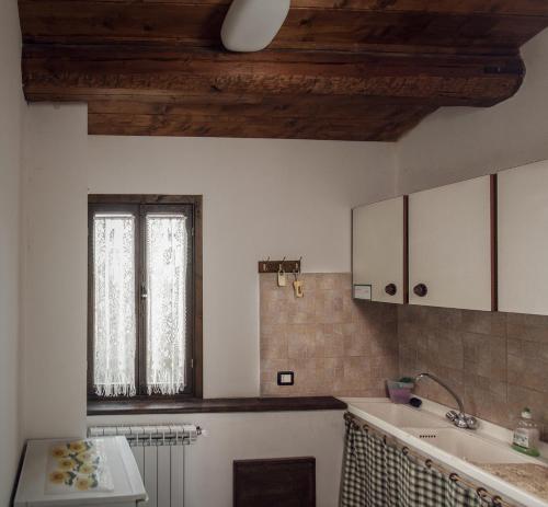 cocina con fregadero y ventana en Agriturismo Via del Campo, en Pianella