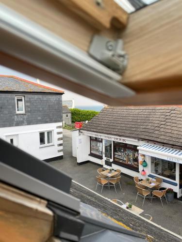a model of a building with chairs and a table at Sea Glimpses Studio Port Isaac in Port Isaac