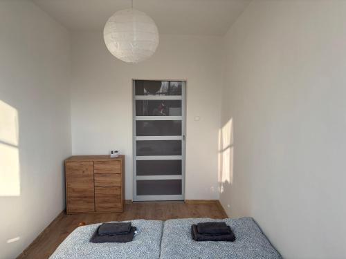 a bedroom with a bed and a dresser in it at Apartment close to Sziget festival in Budapest