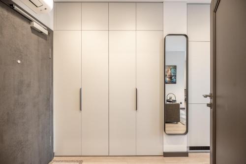 Habitación con espejo y pared blanca en Brand New Downtown Apartments by Reside Baltic, en Vilna