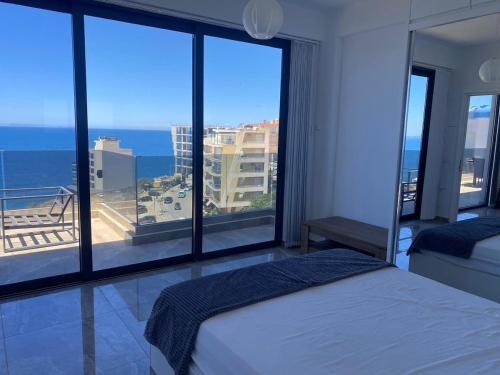 a bedroom with a bed and a view of the ocean at Beachfront luxury Penthouse in Sarandë