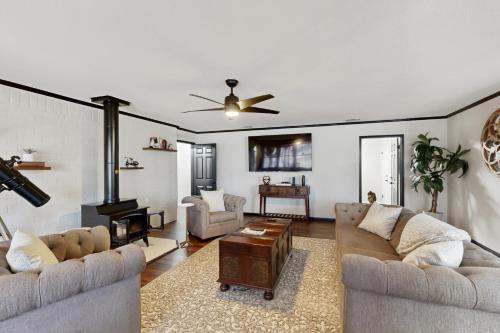 a living room with two couches and a fireplace at Grape Expectations in Fredericksburg