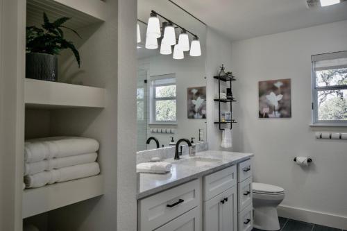 a white bathroom with a sink and a toilet at Ranchview Retreat in the heart of Johnson City in Johnson City