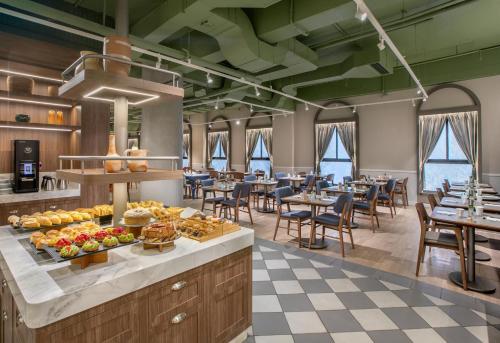 a breakfast buffet in a restaurant with tables and chairs at INNSiDE by Meliá São Paulo Higienópolis in Sao Paulo