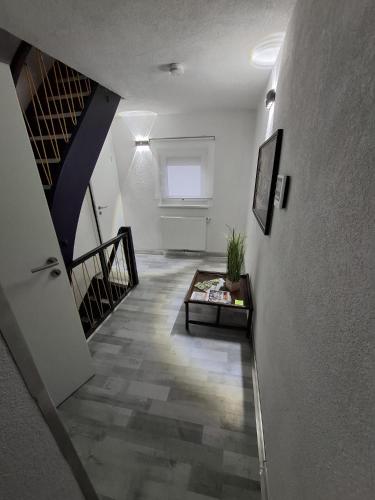 a hallway with a staircase and a living room at GRooms in Gemmrigheim