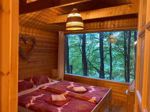 a bedroom with a bed in a log cabin at Kerca Bio Farm in Kercaszomor