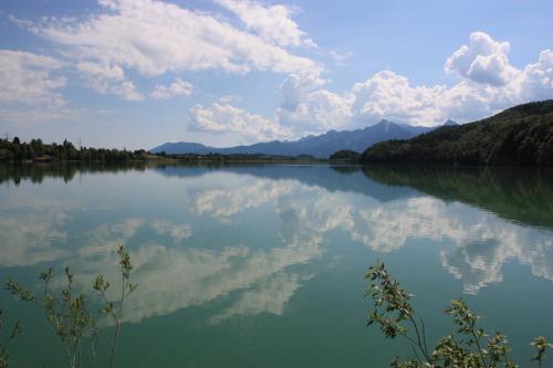 a view of a lake with clouds in the water at Landhaus Seehof in Füssen