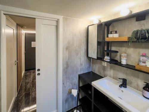 a bathroom with a sink and a mirror at ÅNDALSNES UNDERGROUND flat in Åndalsnes