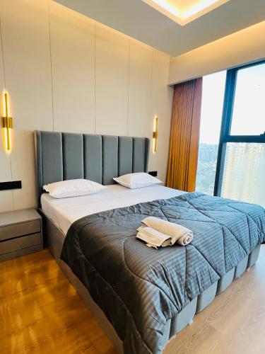 a bedroom with a large bed with a large window at Luxurious Suite with Panoramic glass wall in Ghaziabad