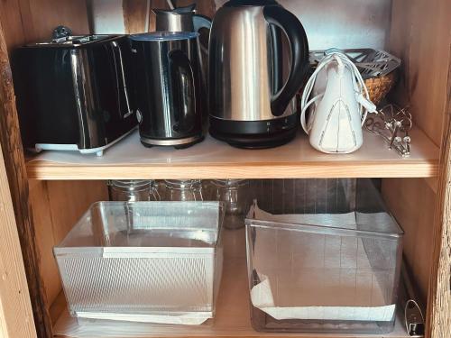 a wooden shelf with some pots and pans at Ickelhaus 2 in Bad Windsheim