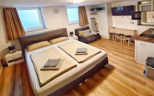 a bedroom with a large bed and a living room at Stuttgart City Apartment A in Stuttgart