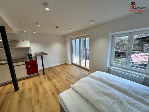 a large bedroom with a large bed and a table at Altstadt Apartments in Schongau