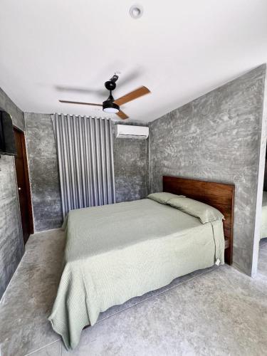 a bedroom with a bed and a ceiling fan at Villa pio blue in Santa Veronica