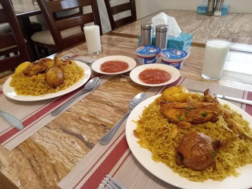 a table with three plates of food on it at Petra Premium Hotel in Wadi Musa