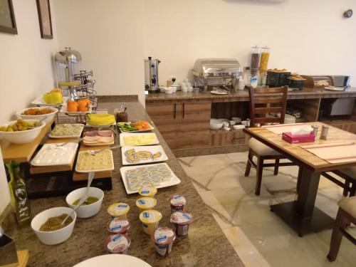 a kitchen with a table with many plates of food at Petra Premium Hotel in Wadi Musa