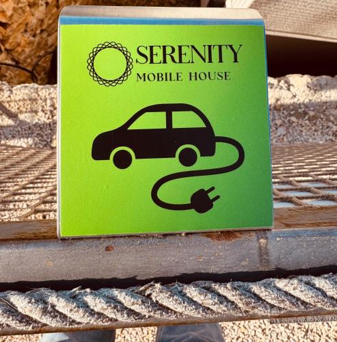 a green sign on a table with a car at Serenity Mobile House in Drage