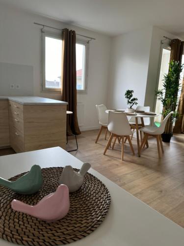 ブシー・サン ・ジョルジュにあるLogement familial près de Disneyの3羽のアヒルが置かれたテーブルのあるリビングルーム