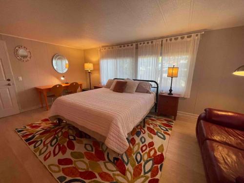 a bedroom with a bed and a rug at Riverbed House in Middletown