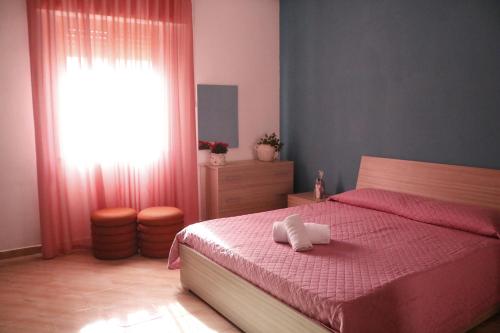 Ένα ή περισσότερα κρεβάτια σε δωμάτιο στο Sibilla Vacanze