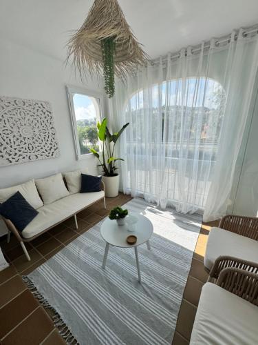 a living room with a couch and a table at Puerto De La Duquesa in Manilva