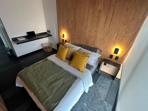 a bedroom with a large bed with yellow pillows at Apartment with balcony in the heart of the city in Mexico City