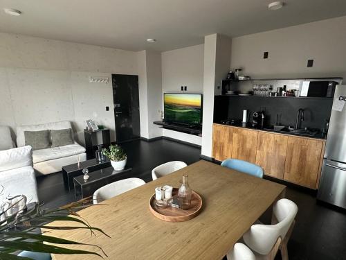 a living room with a dining table and a kitchen at Apartment with balcony in the heart of the city in Mexico City