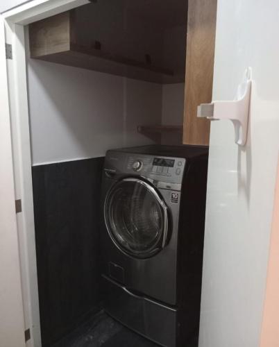 a washer and dryer in a small kitchen at Apartment with balcony in the heart of the city in Mexico City