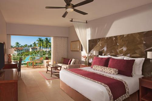 a bedroom with a large bed and a living room at Dreams Royal Beach Punta Cana - All Inclusive in Punta Cana