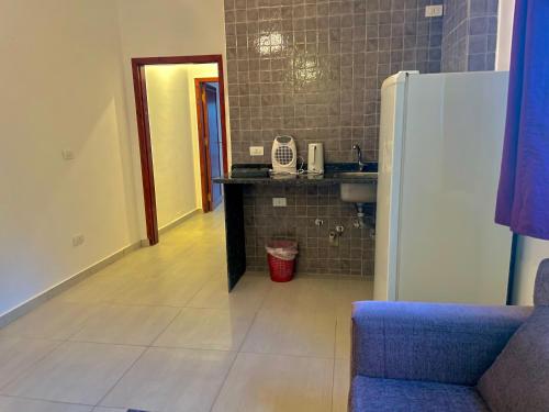 a kitchen with a sink and a refrigerator at Nile Panorama Hotel in Luxor