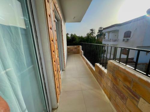 a balcony of a house with a glass door at Nile Panorama Hotel in Luxor