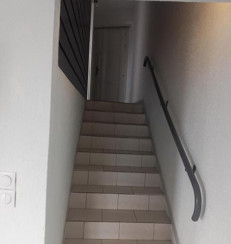 a stairway with a set of stairs leading to a door at residence de la baie in Les Trois-Îlets