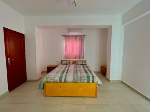 a bedroom with a bed with a red window at Nile Panorama Hotel in Luxor