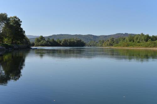 a view of a river with trees in the distance at Banja na Drini - Lux vikendice, apartmani, na obali reke in Banja Koviljača