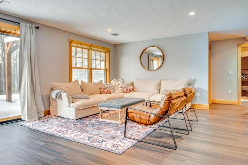 a living room with a couch and a table at 6 Mi to Lake Winnipesaukee New Hampshire Home in Gilford