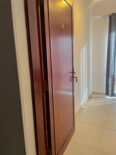 a wooden door in a room with a hallway at Nile Panorama Hotel in Luxor