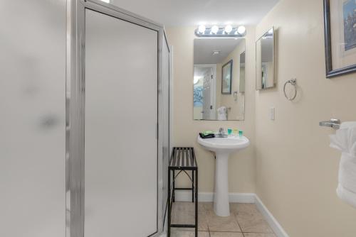 a white bathroom with a sink and a shower at Pelican Isle 206 in Fort Walton Beach
