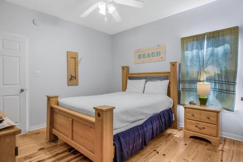 a bedroom with a bed with a wooden bed frame at The Rookery 1302 by Vacation Homes Collection in Fort Morgan