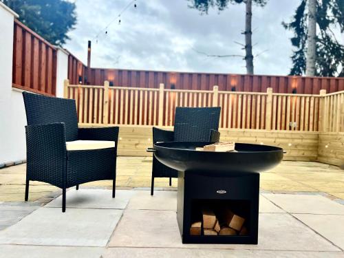 a table and chairs and a sink on a patio at Large House for 21 - Nottingham City in Nottingham