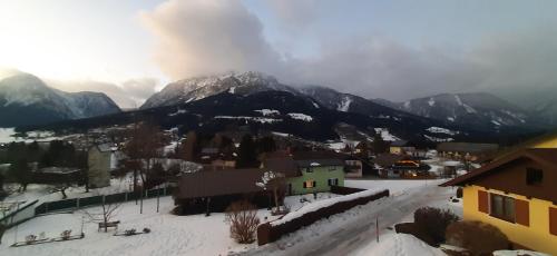 a town with a snow covered mountain in the background at Panoramatraum in Gersdorf