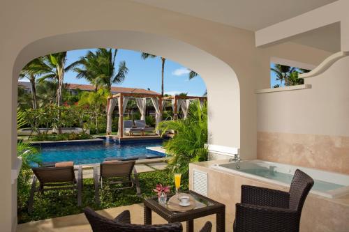 an archway leading to a swimming pool and a villa at Secrets Royal Beach Punta Cana - Adults Only - All Inclusive in Punta Cana