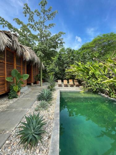 a swimming pool in front of a house at Casa Bahareque in Puerto Escondido