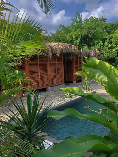 a small hut with a pool in front of it at Casa Bahareque in Puerto Escondido