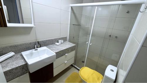 a small bathroom with a sink and a shower at Parque do Cais - Flats Premium no Recife por Yolo in Recife