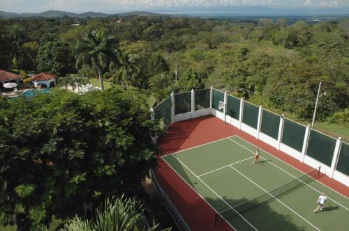 an aerial view of a tennis court with two people on it at El Castillo de Esparza in Esparza